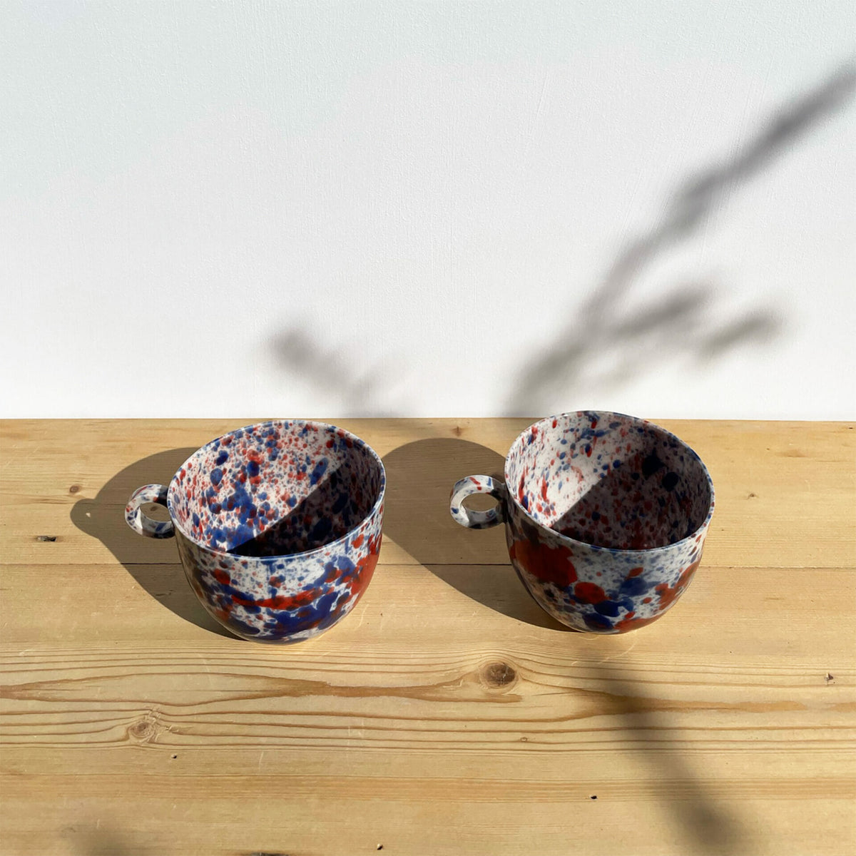 blue-and-red-splatter-mug-drips-splashes-colour-pottery-cup-circle-handle