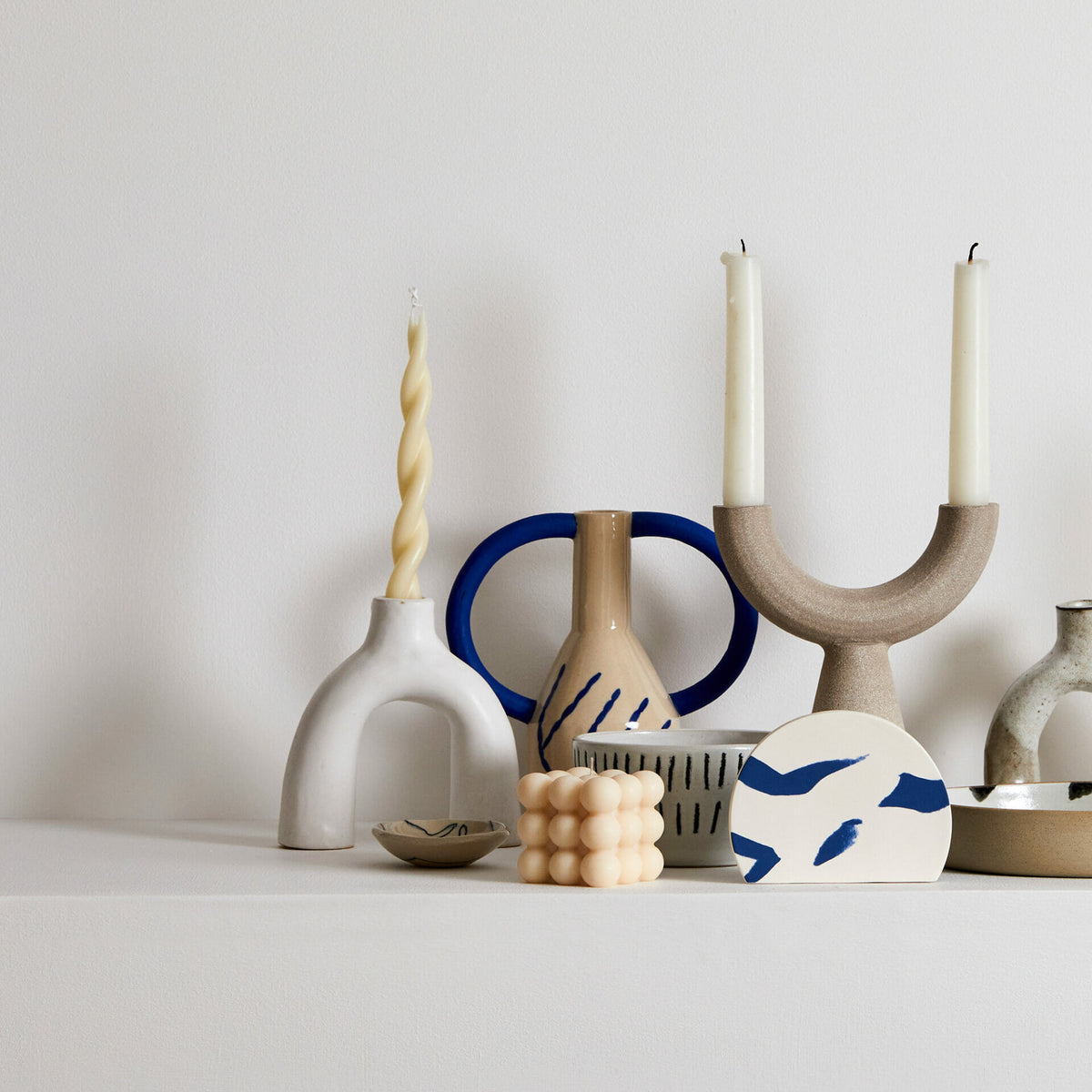 White-leggy-ceramic-handmade-cream-shaped-like-upsidedown-letter-"U"
