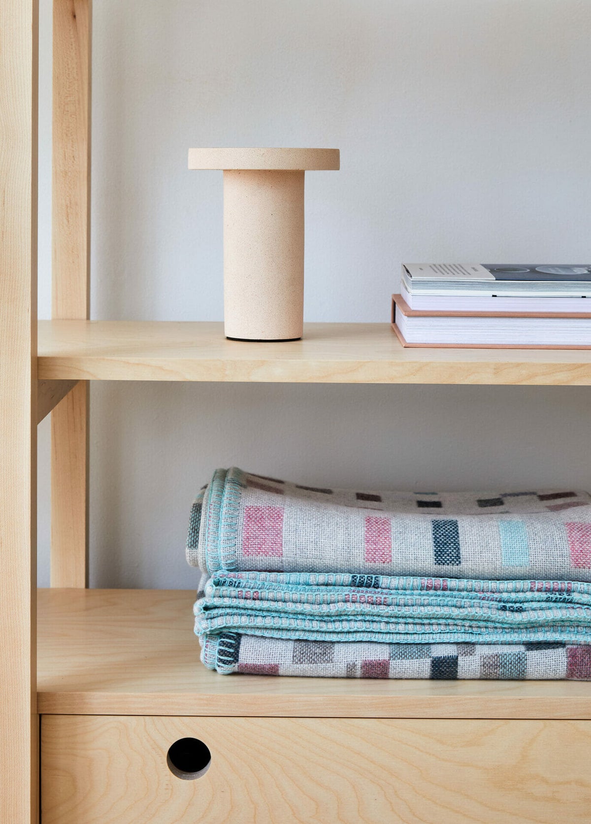 macaron-blanket-textiles-design-candleholder-books-shelving-furniture-design
