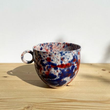 blue-and-red-splatter-mug-porcelain-drips-splashes-colour-pottery-cup-circle-handle